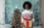 Small business owner holding a present at a photoshoot to get content for their Christmas marketing strategies