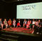 Panel of women on stage under a screen reading SUCCESS Redefined, smiling in a lively discussion reflecting what happens at a book launch event