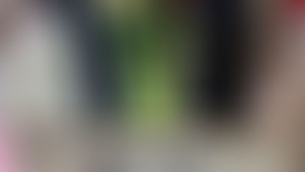 Vase with pink tulips on display at Elladora Boutique in Athabasca Alberta. Sign in foreground, clothes and accessories in background create a chic setting in a women's clothing store.