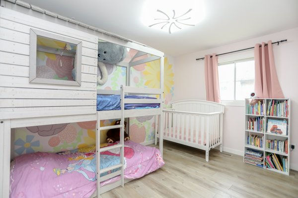 Girls bedroom with hand-painted floral mural after renovation