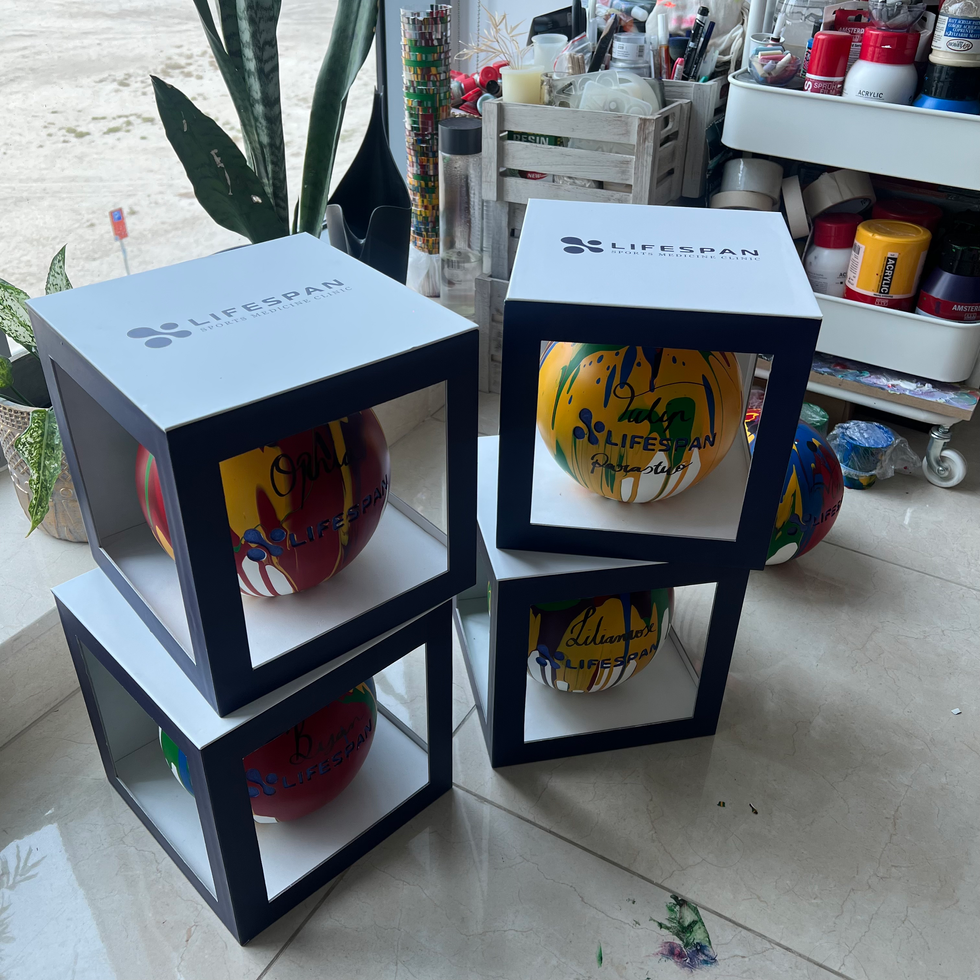 Acrylic Pour Technique on fiberglass spheres for Lifespan Sports Medicine Clinic's event. @TheCryingCanvas