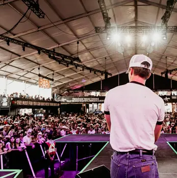 Nik Poli looking out into the crowd at Cowboys Music Festival 2024