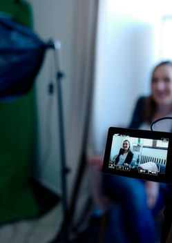 Close up image of a viewfinder of a video camera during an interview