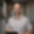 image of man wearing a gray shirt and holding a clipboard