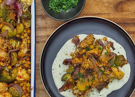 Tray of roasted vegetables & chicken on a chili yoghurt sauce