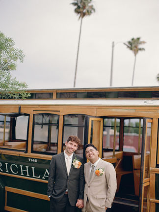 The grooms smiling, in the background is the Richland bus