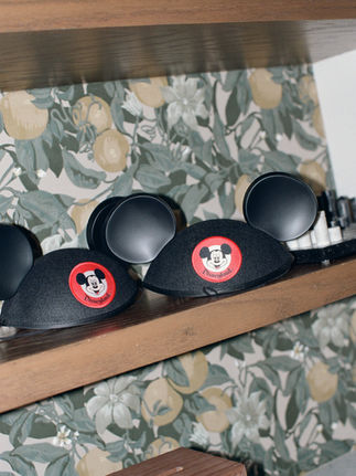 Cute mickey mouse hats displayed on the shelf.
