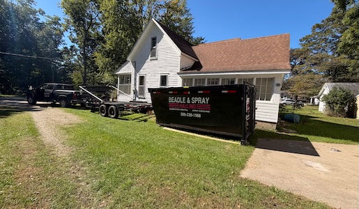 Beadle & Spray roll-off dumpster delivered beside a residential driveway in Allegan, Michigan
