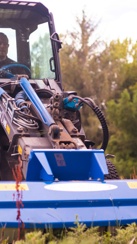 Mowing long grass on a lifestyle block using flail mower and articulated loader