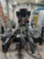 Vehicle chassis detached from body in a workshop