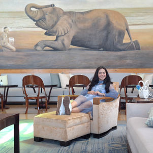 Sheilla Joveline sitting on some custom furniture from Indonesia