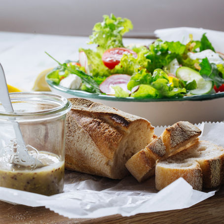 A plate of salad and slice of sourdough bread