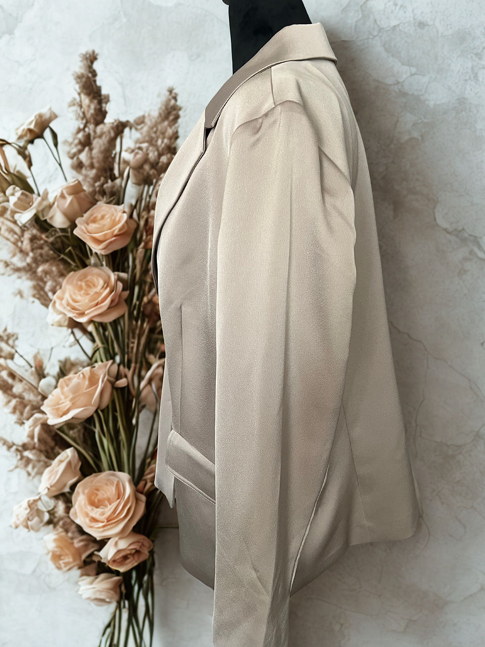 Cream satin look blazer, Chico's Black Label, displayed with floral accents in boutique.