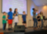Global Children leading worship in a Sunday Celebration Service