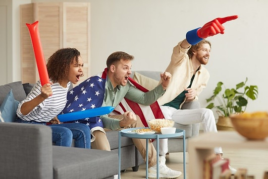 side-view-group-young-people-watching-sports-match-tv-home-cheering-emotionally-while-wear