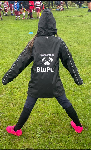 A young girl showing off her BluPug jacket.