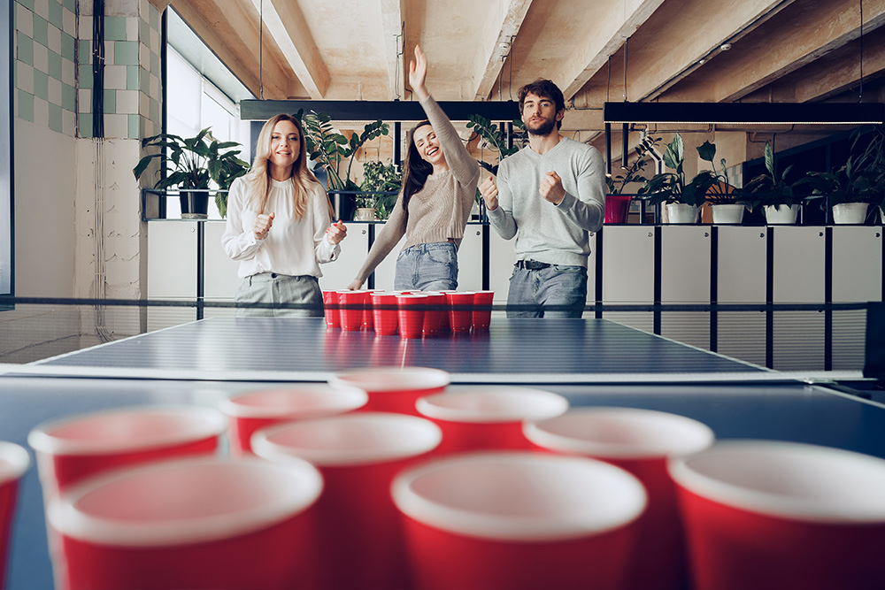 young-people-coworkers-playing-beer-pong-modern-office.jpg