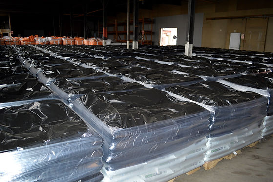 Bagged rock salt on pallets stored in warehouse