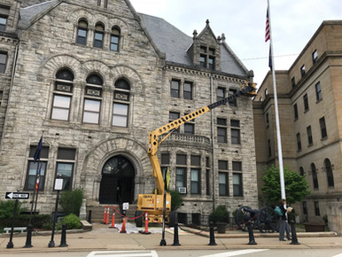 Crane in front of exterior of Fayette County Courthouse