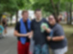 Three residents smile together while walking through Idewild Park.
