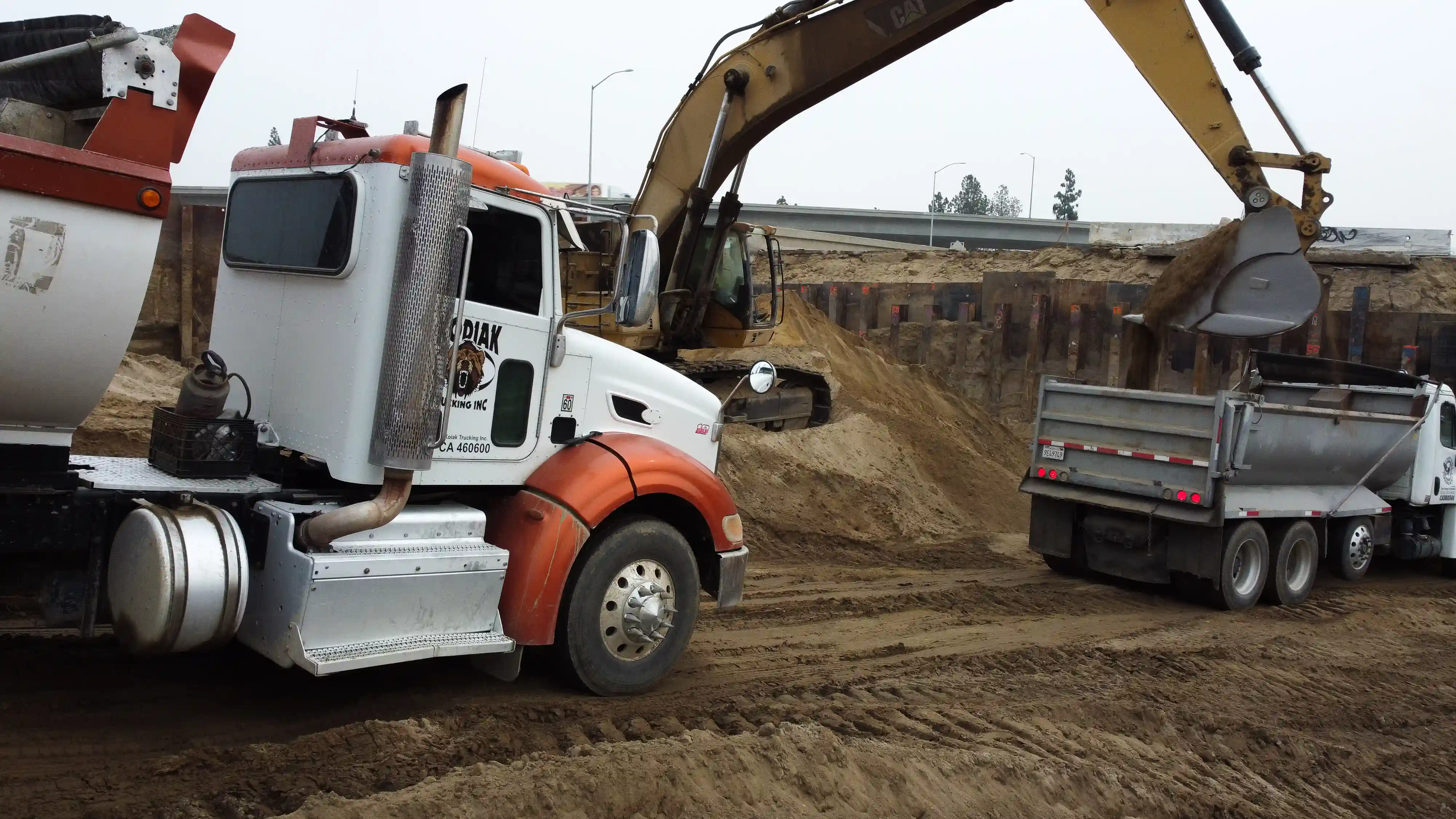 clean-two-trucks-hauling-dirt