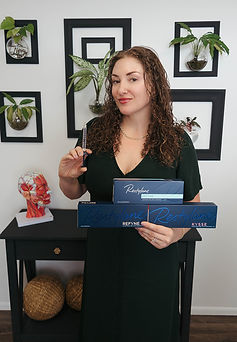 A picture of lip filler product being held by Christina Carlee APRN, owner Evercare Wellness