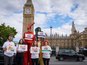 Campaigners outside of Big Ben in London wiht campaign message placards stating 'protect the 'pods' with stilt walkers dressed as a crab and lobster