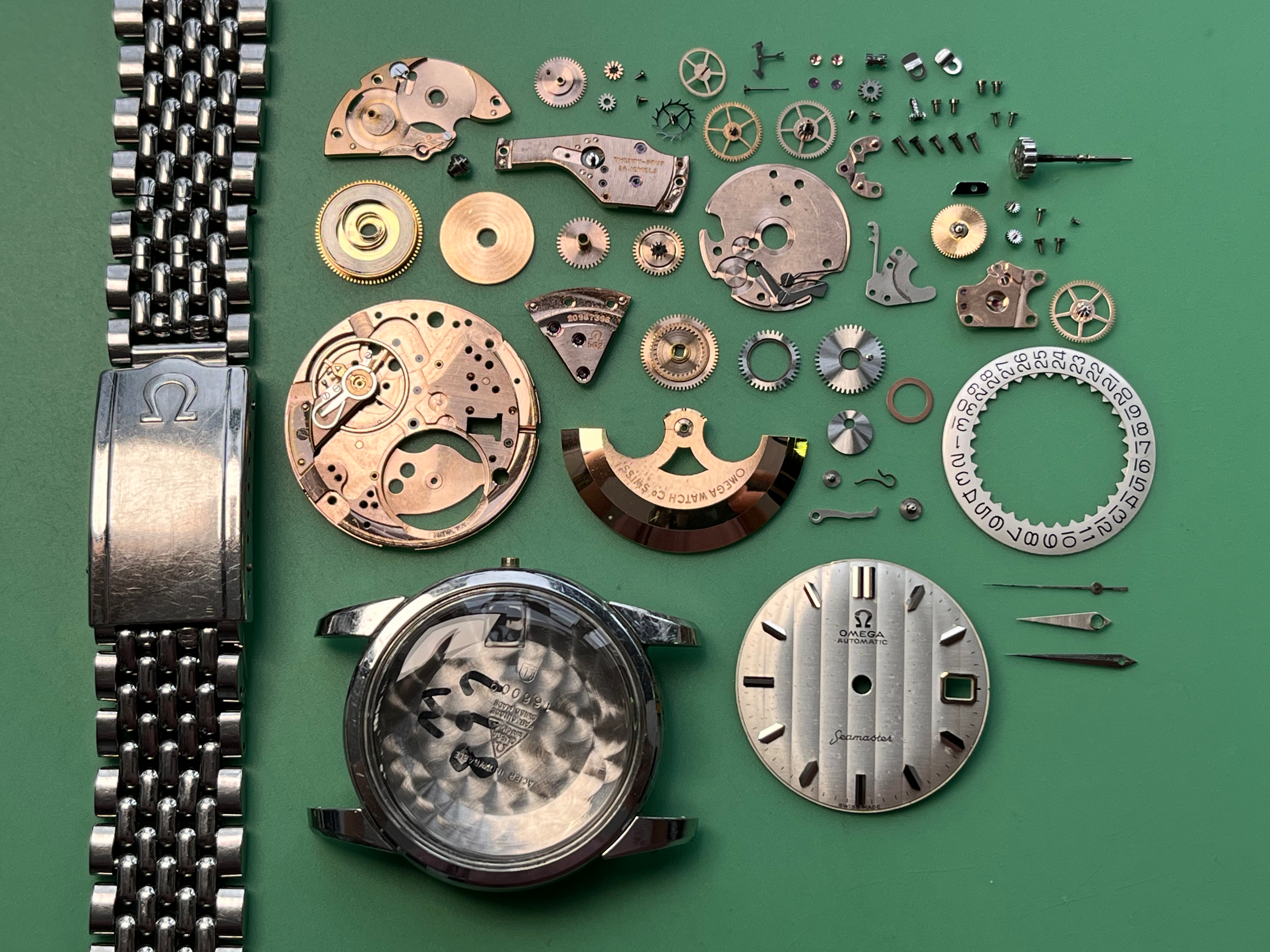 Omega Seamaster 166.009. Disassembled watch and documented service parts. · Photo: Tempo Prima · © Tempo Prima; permission not yet confirmed · Source: https://www.tempoprima.com/product-page/vintage-1963-omega-seamaster-serviced-special-ribbion-dial