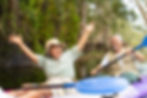 Elder couple enjoying an outdoor kayaking adventure together.