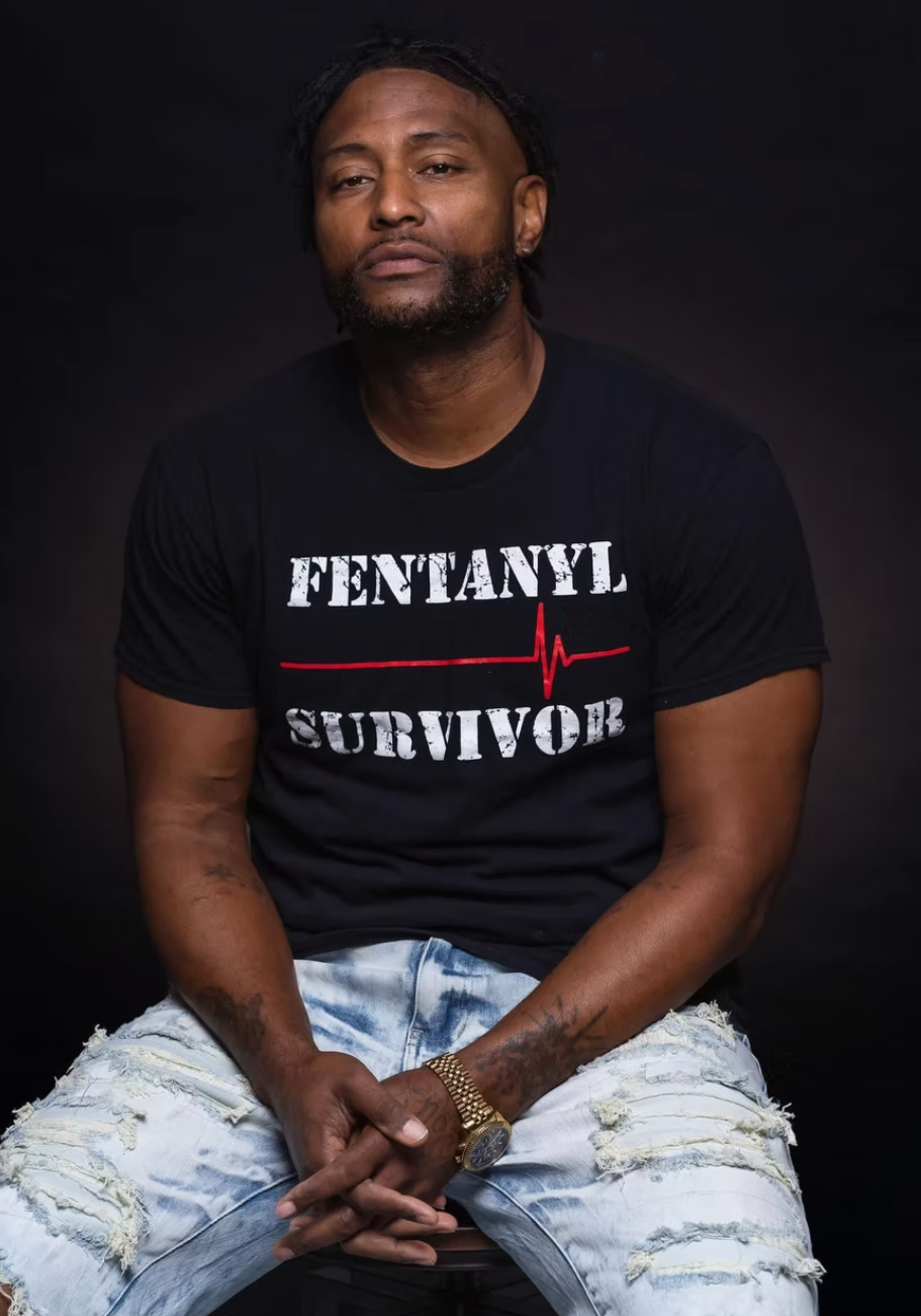180 Slim wearing Fentanyl Survivor shirt, blessed and highly favored artist