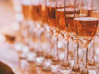 A row of elegantly filled champagne glasses ready for a celebratory toast.