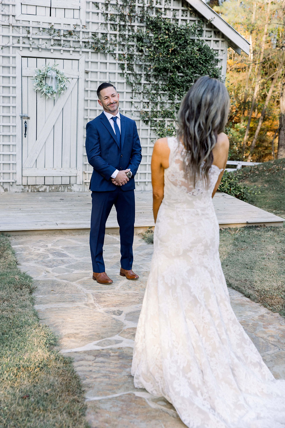 bride and groom during first look at tuscaloosa alabama outdoor wedding venue