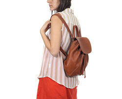 Woman wearing backpack from side