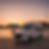 White luxury transportation van at sunset by the water
