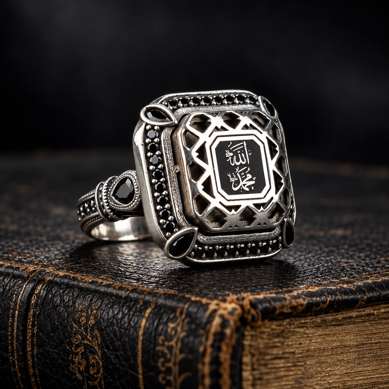 Allah and Muhammad calligraphy sterling silver men's ring on a black leather book