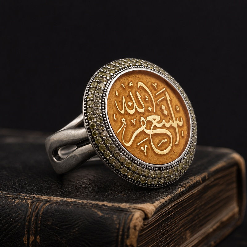 Astaghfirullah Golden Calligraphy Sterling Silver Ring side view on a dark leather book