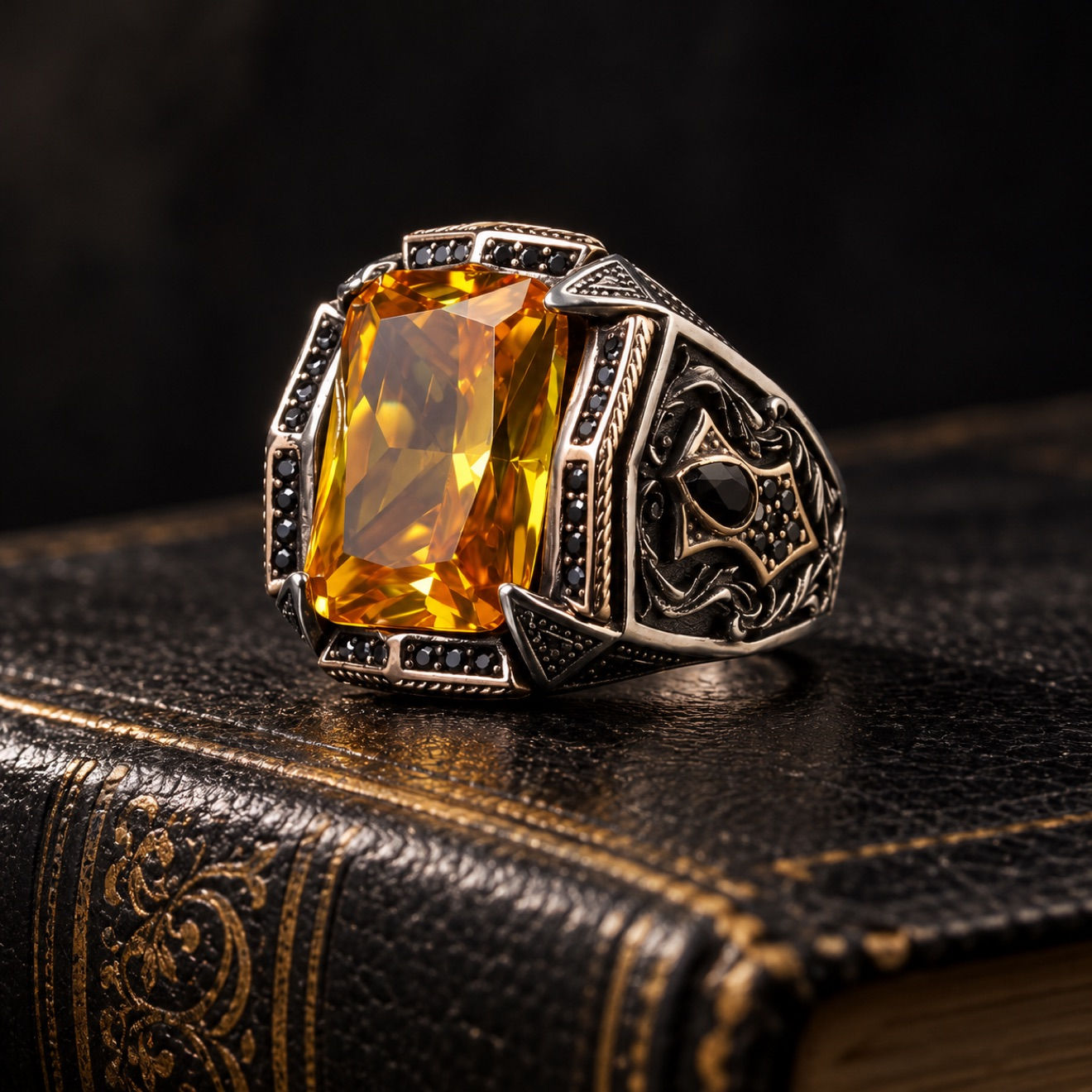 Citrine black accent sterling silver men's ring on a black leather book