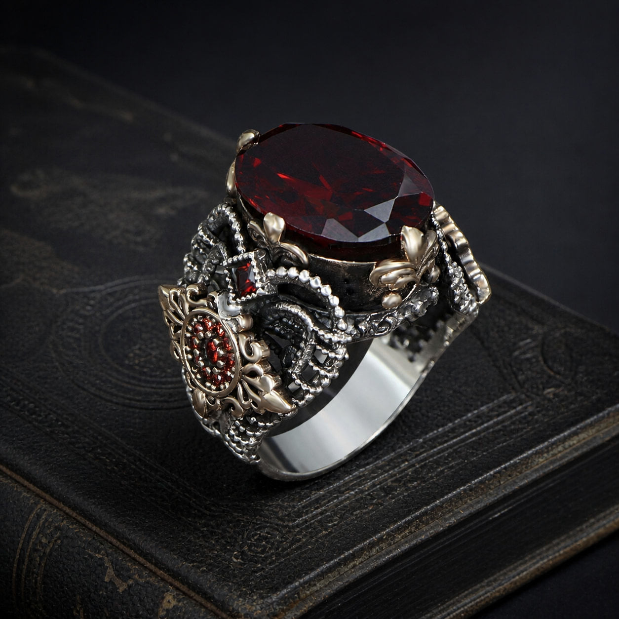 Red Zircon Floral Sterling Silver Men's Ring on a black leather book
