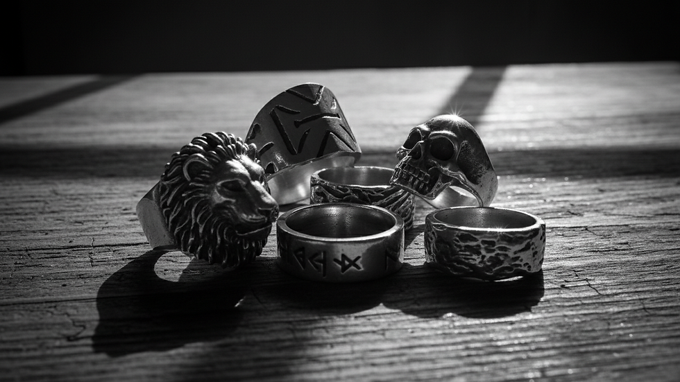 Eye-level view of a collection of men's silver rings with various designs