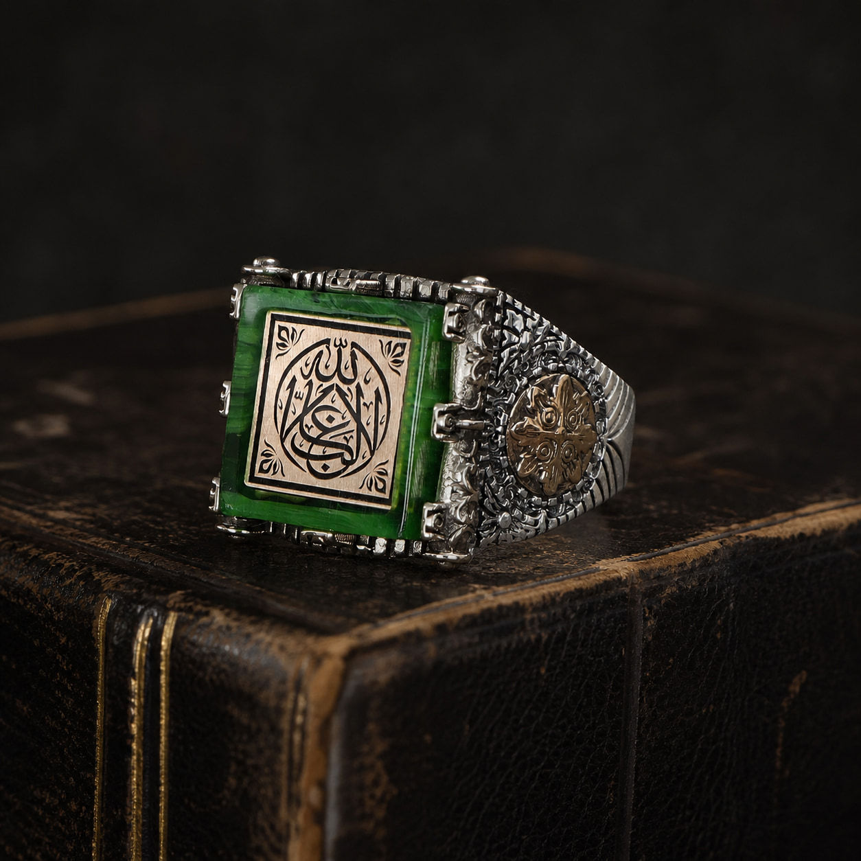 La Ghalib Illallah Amber Sterling Silver Men's Ring on a black leather book
