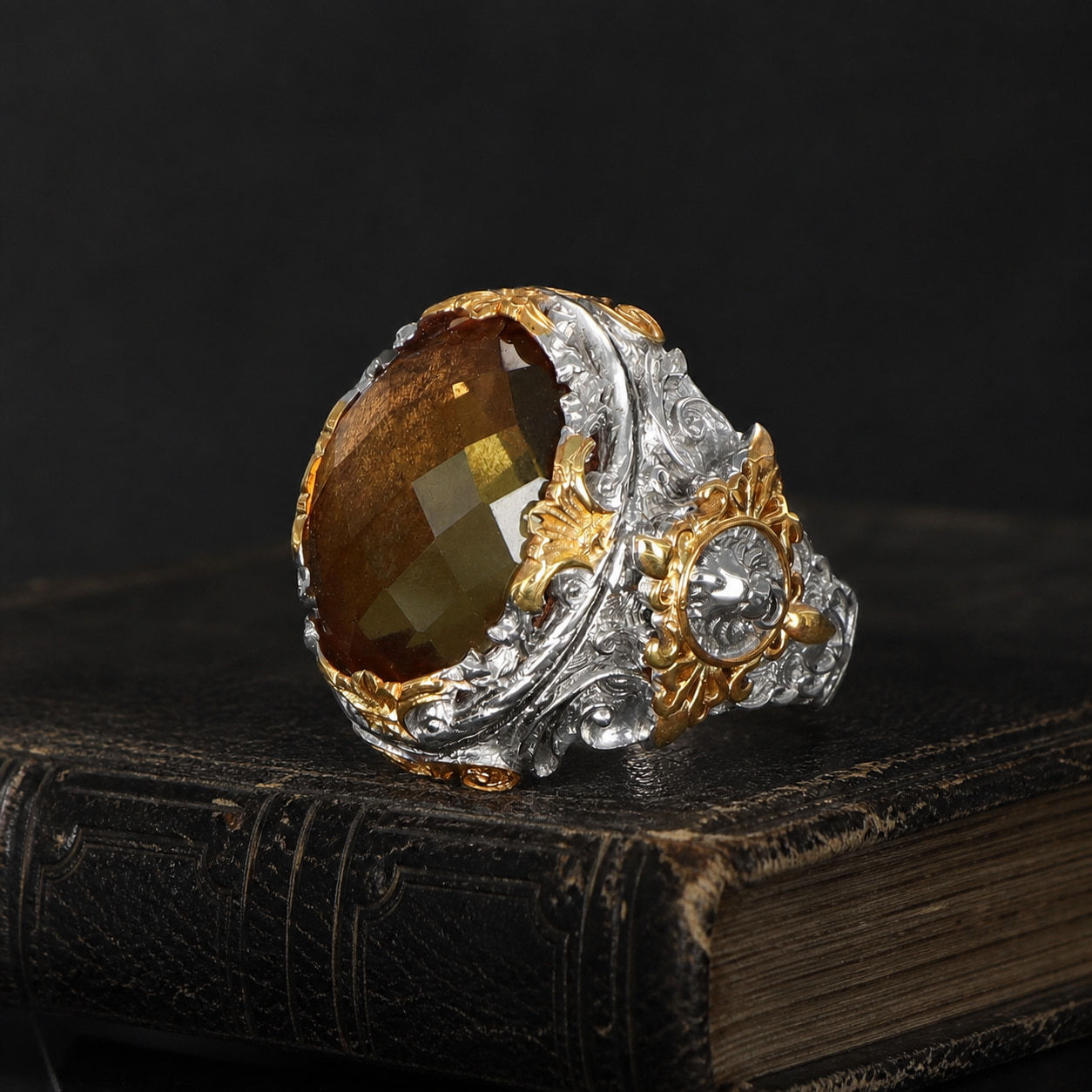 Zultanite Two Tone Sterling Silver Men's Ring on a black leather book