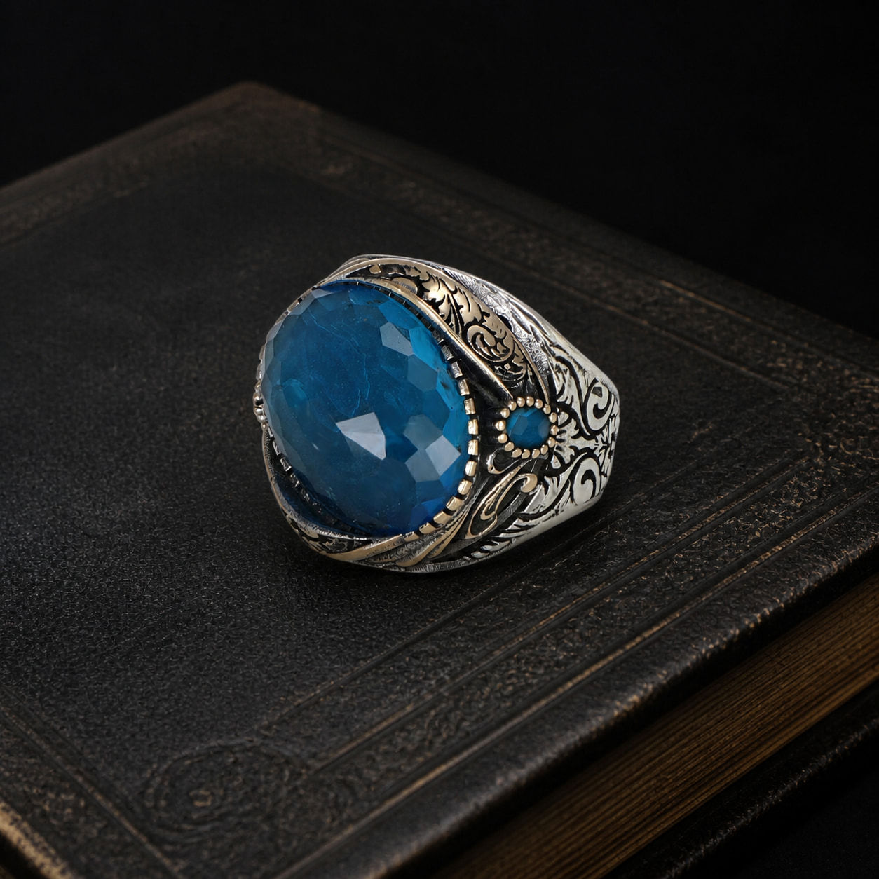 Ornate Aquamarine Sterling Silver Men's Ring on a black leather book