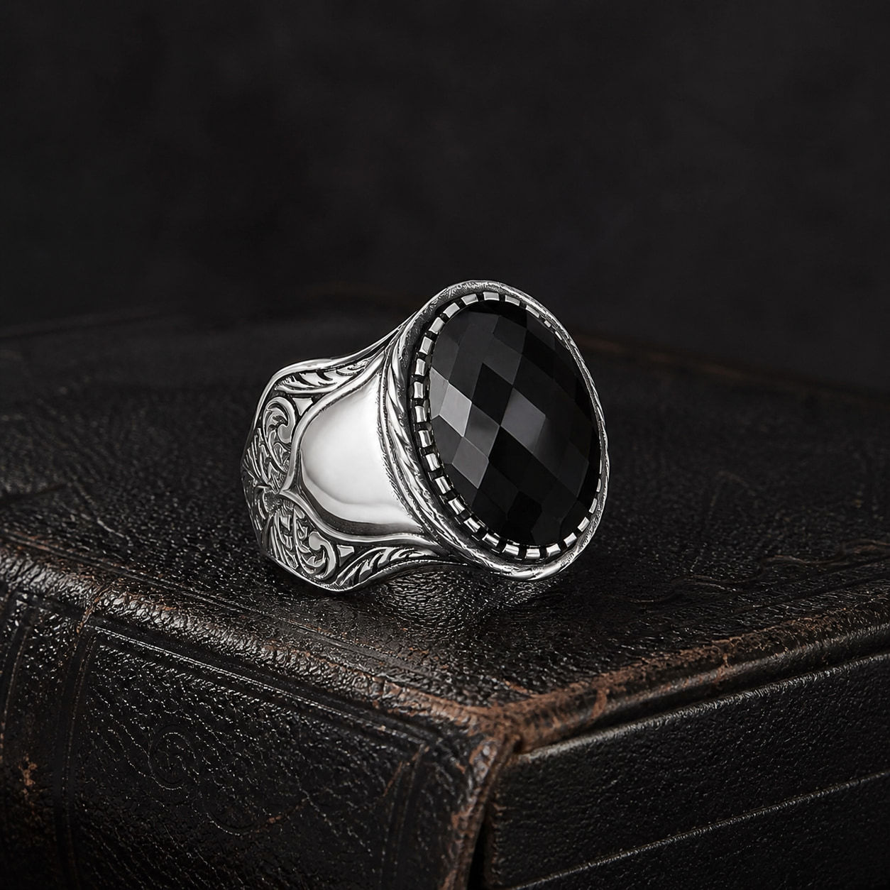 Black Zircon Beaded Sterling Silver Men's Ring on a black leather book