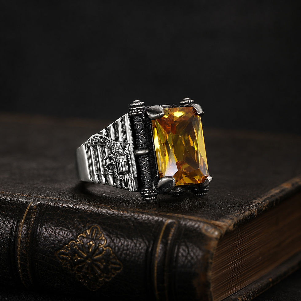 Citrine Gun Motif Sterling Silver Men's Ring displayed on a black leather antique book