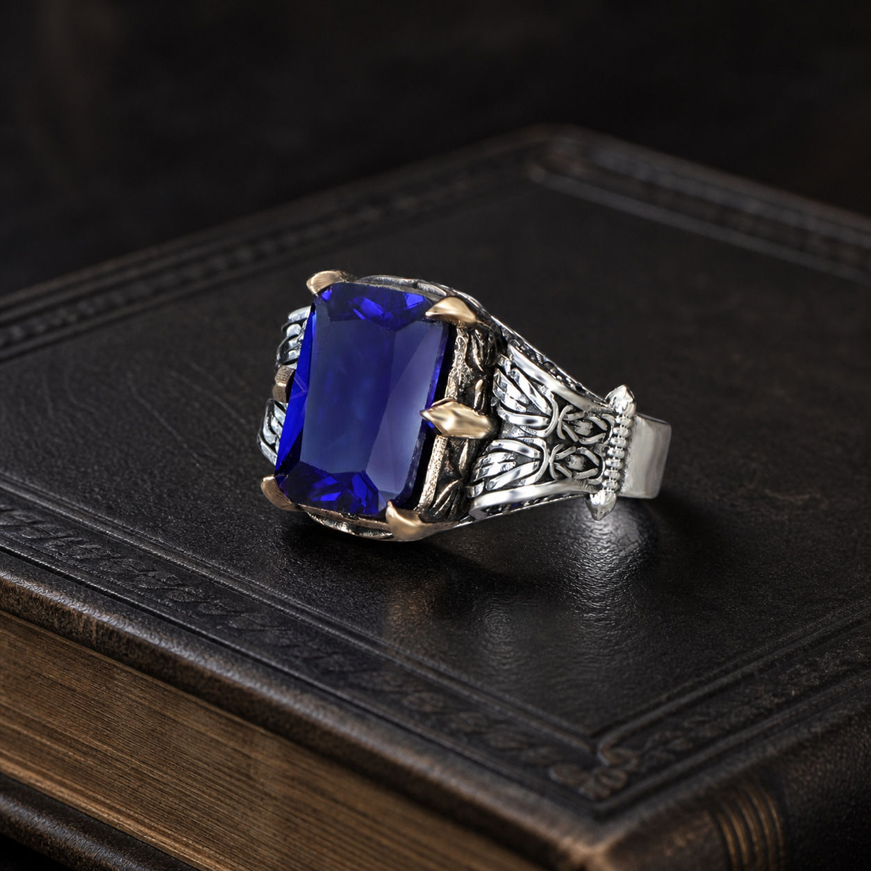 Royal Blue Zircon Chain Motif Sterling Silver Men's Ring displayed on a black leather antique book