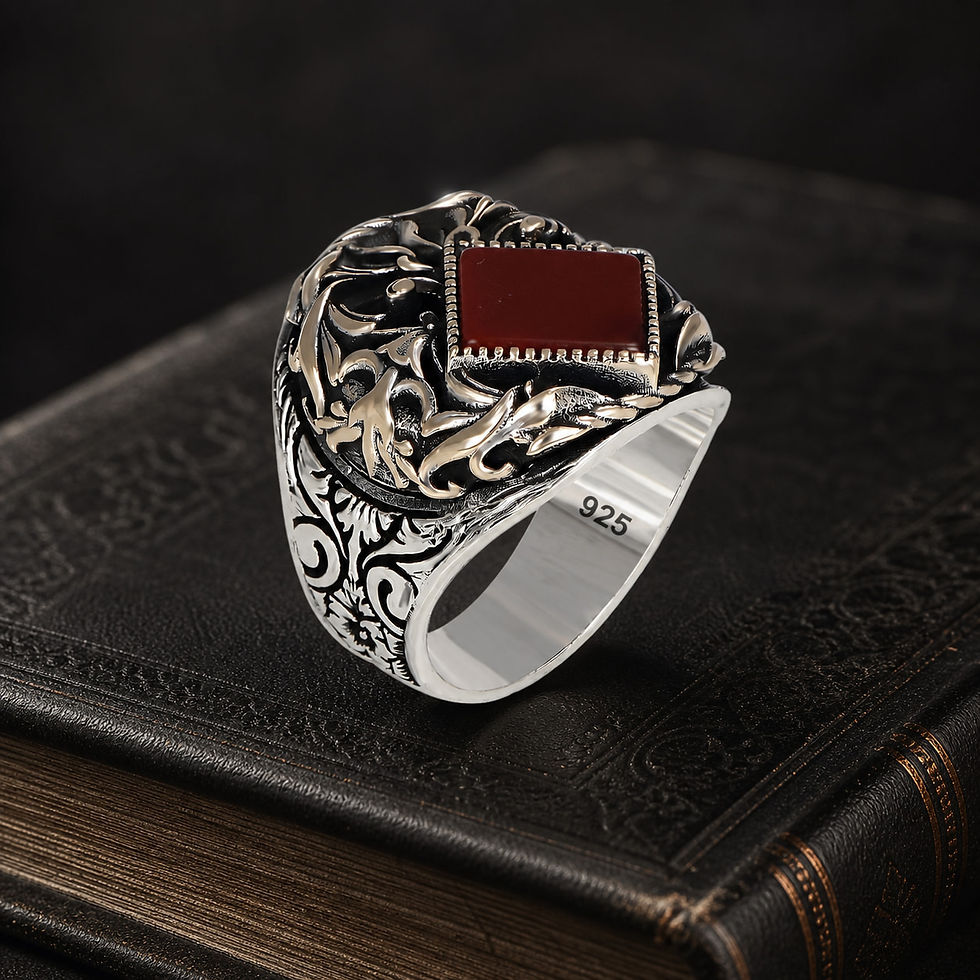 Red Agate Engraved Sterling Silver Men's Ring on a black leather book