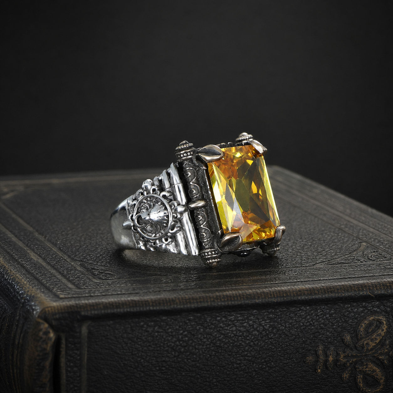 Citrine Medallion Sterling Silver Men's Ring on a black leather antique book