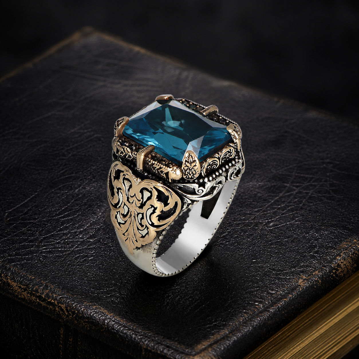 Engraved Aquamarine Sterling Silver Men's Ring on a black leather book