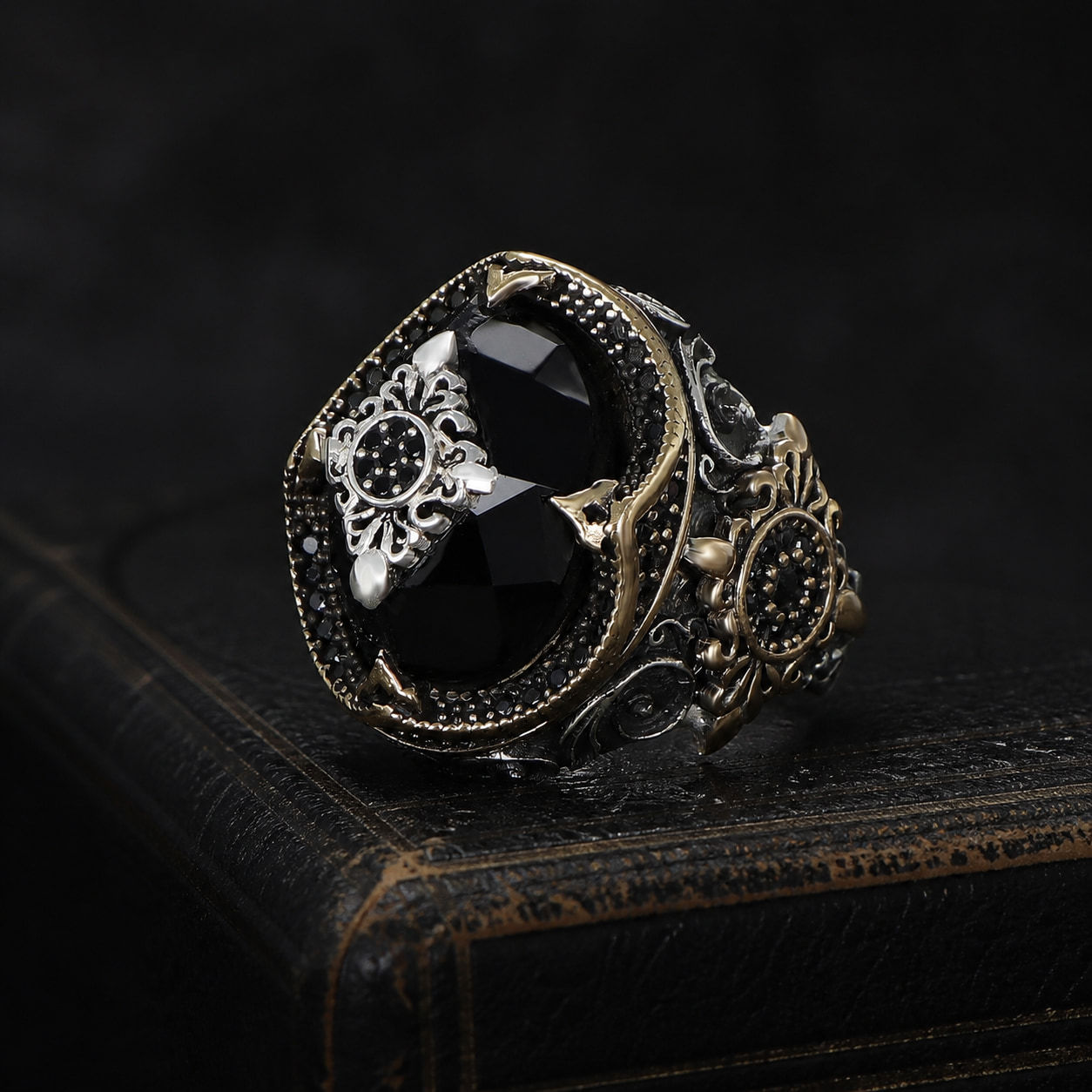 Black Zircon Twin Stone Sterling Silver Men's Ring on a black leather book