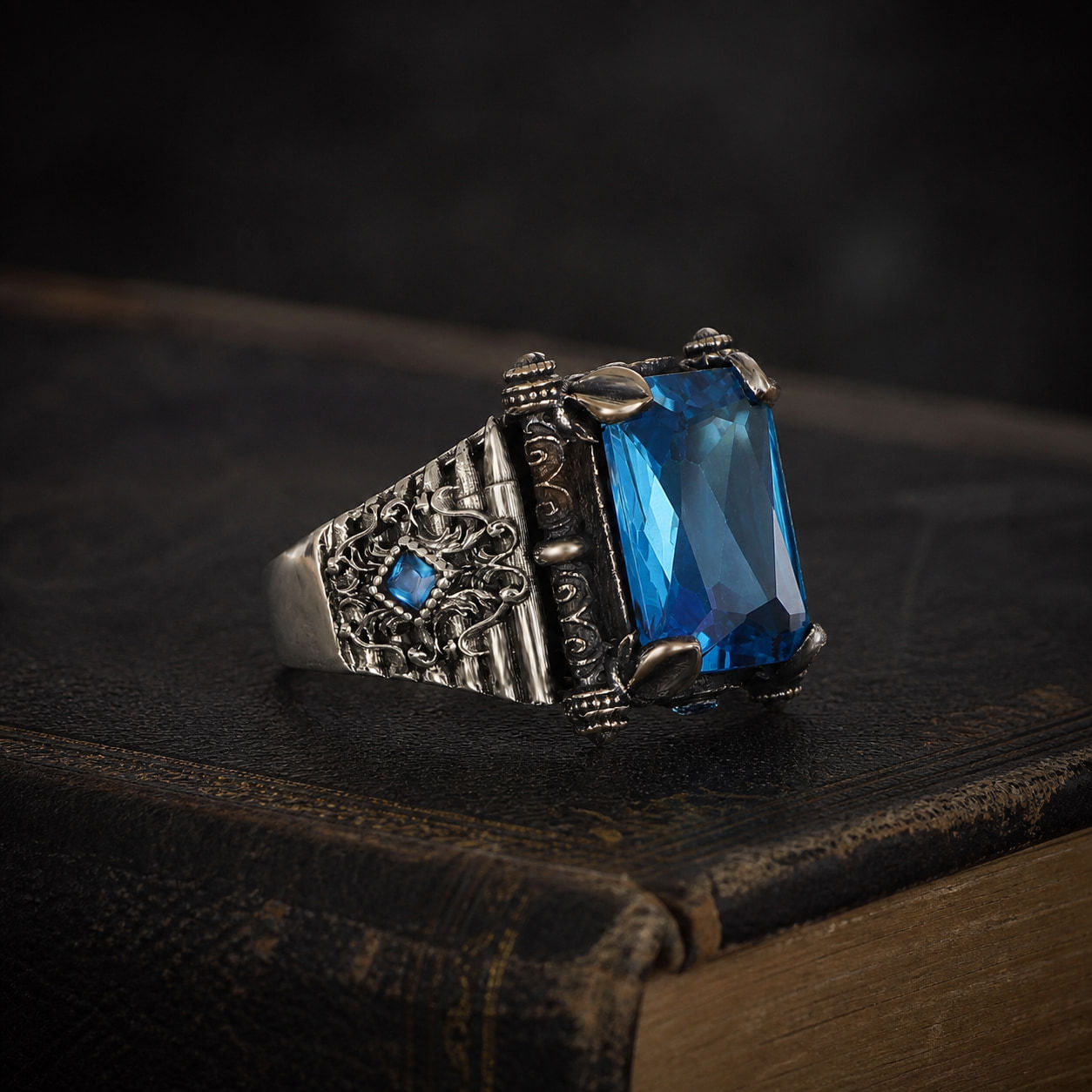 Aquamarine Architectural Sterling Silver Men's Ring displayed on a black leather antique book